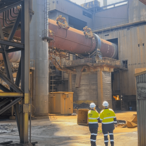 AMC cleaner equipped with PPE, attending to a high-risk industrial cleaning task with precision.